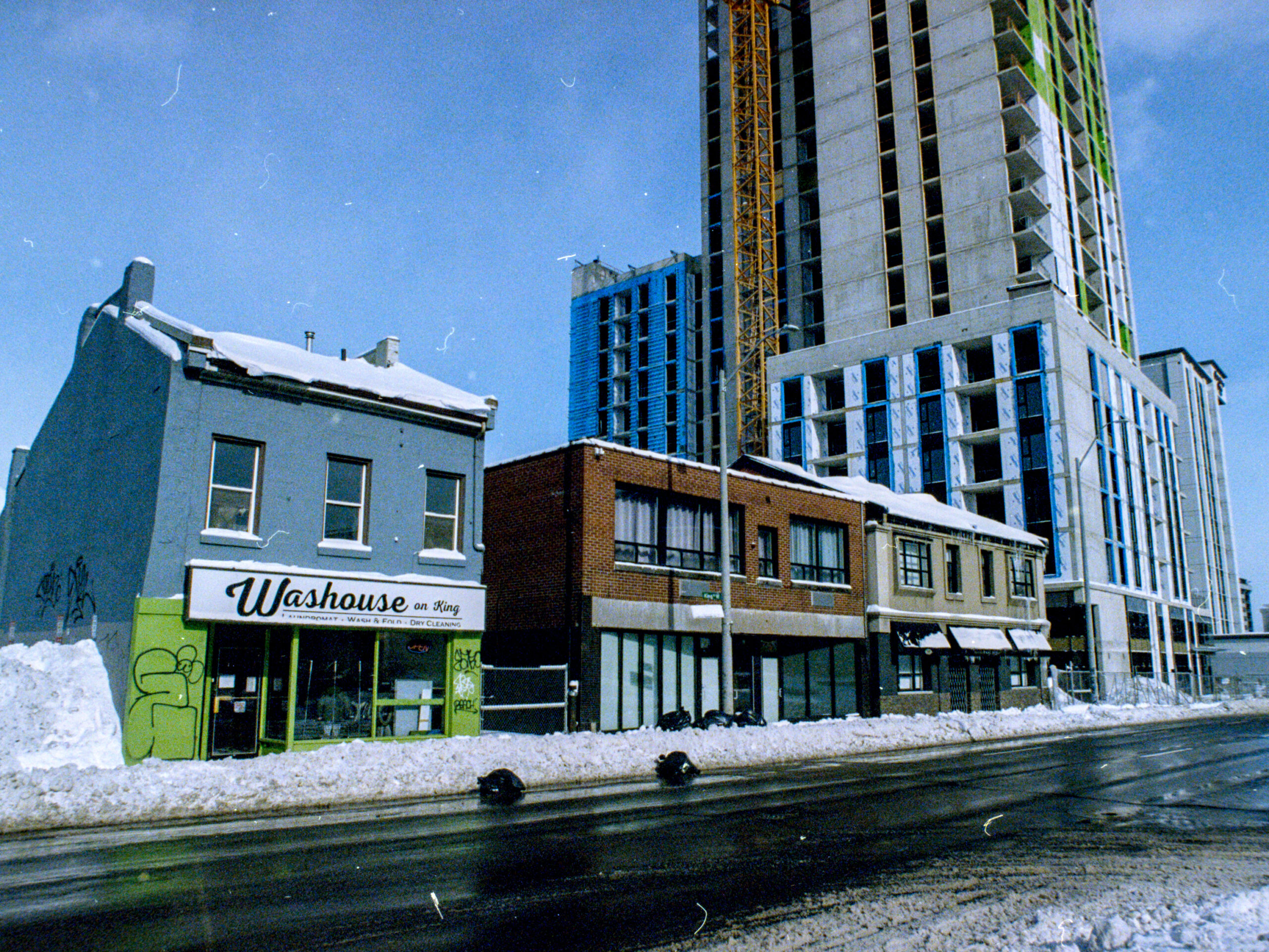 colour photo of a row of buildings next to the street