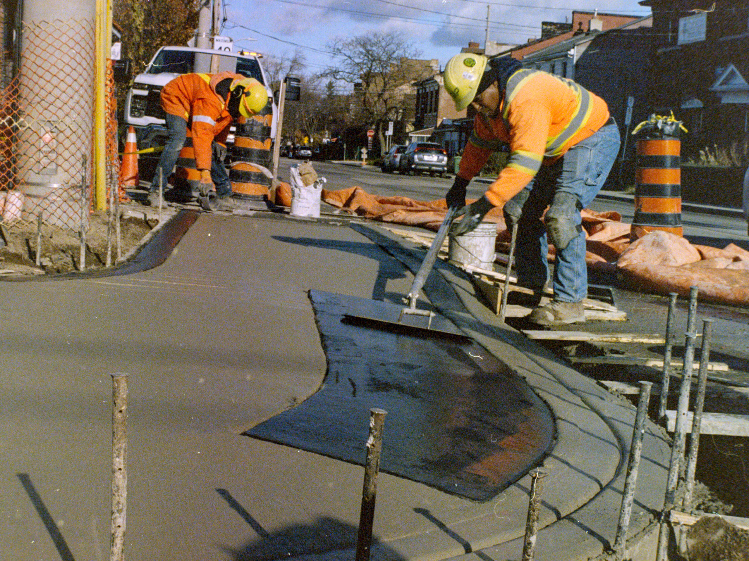 colour photo of two workers smoothing wet concrete