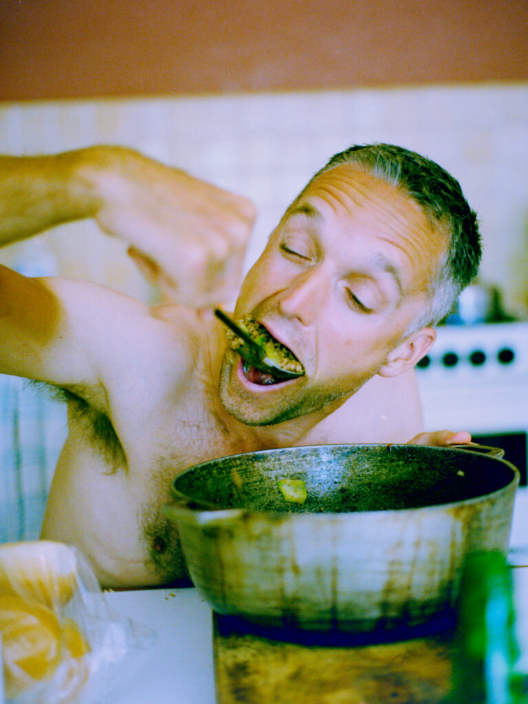 colour photo of young man eating with large spoon