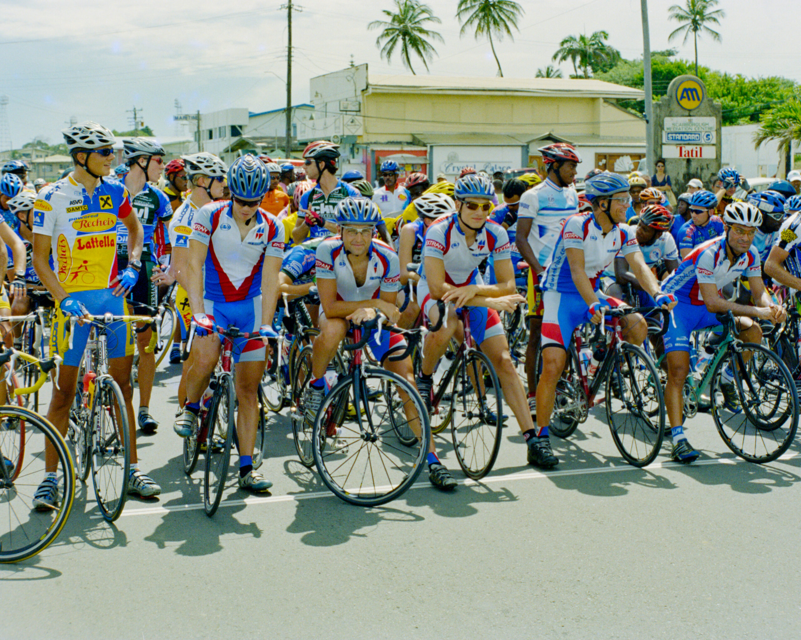 colour photo of road cyclists lining up before starting a race