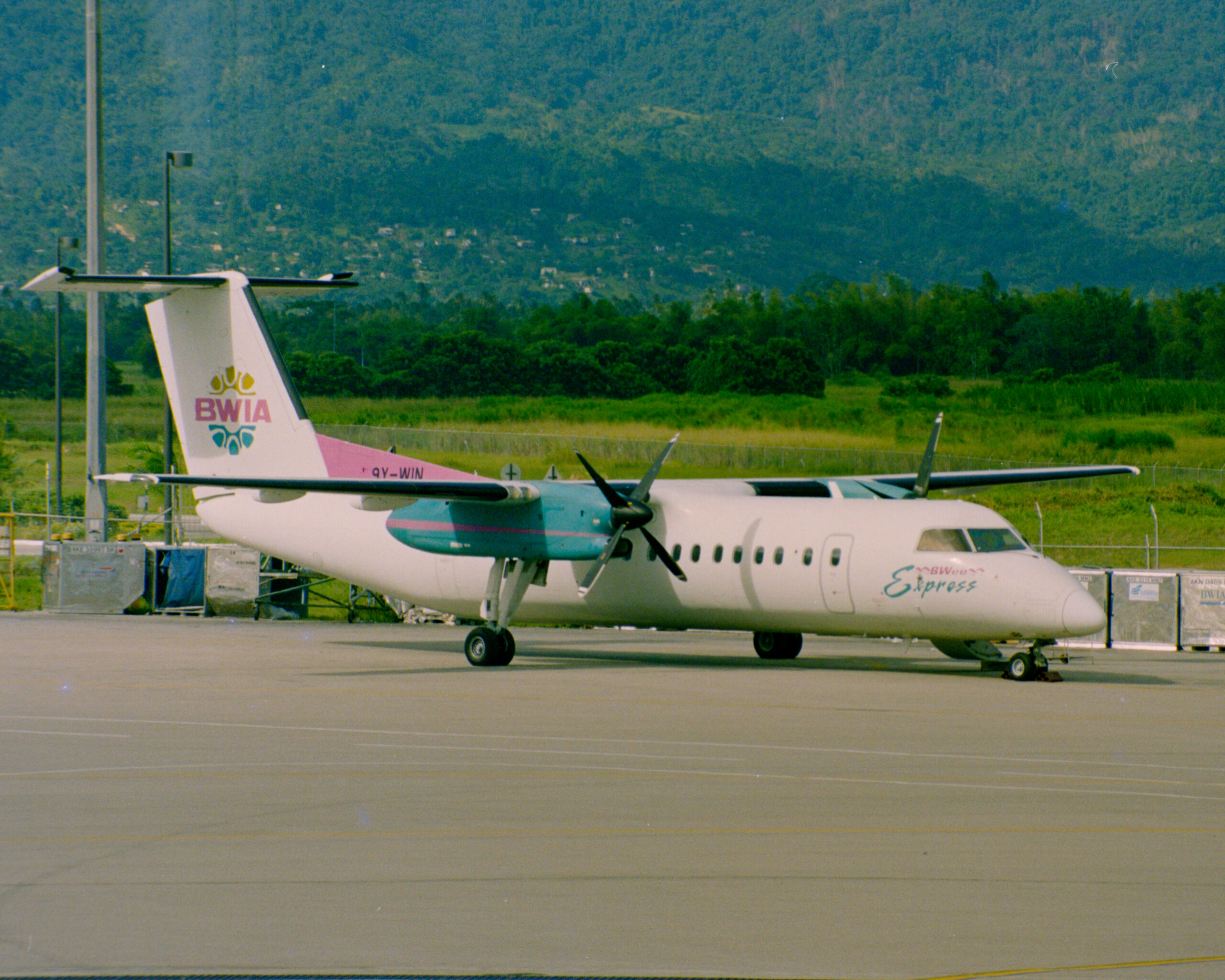 colour photo of a BWIA twin engine propeller plane on the tarmac